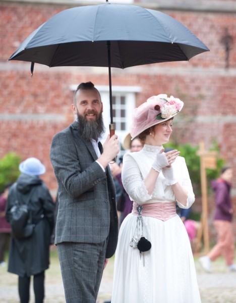 Zwei Personen in historischem Gewand vor dem Schloss vor Husum